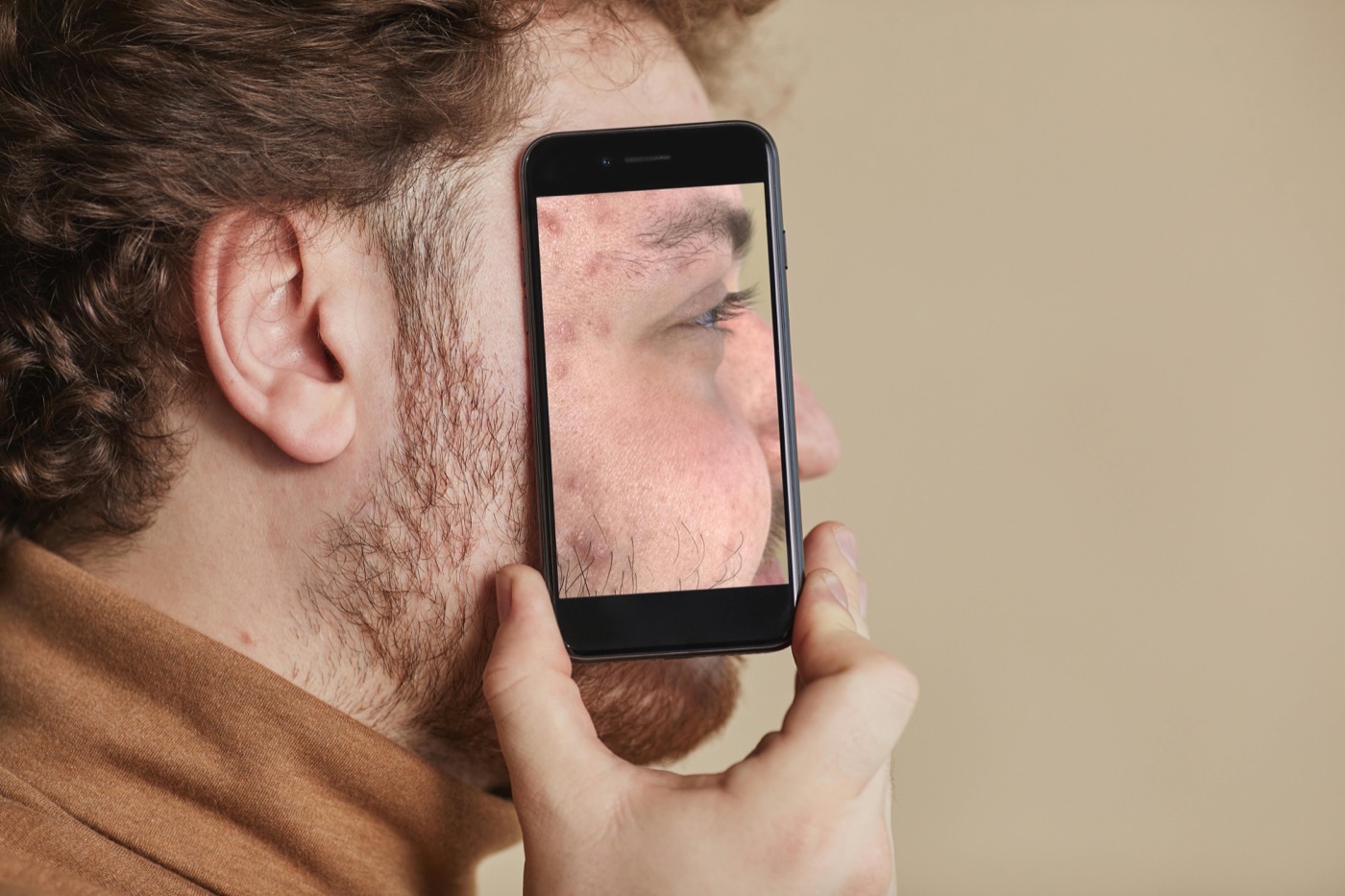 Person scanning skin with Sknsight AI on mobile